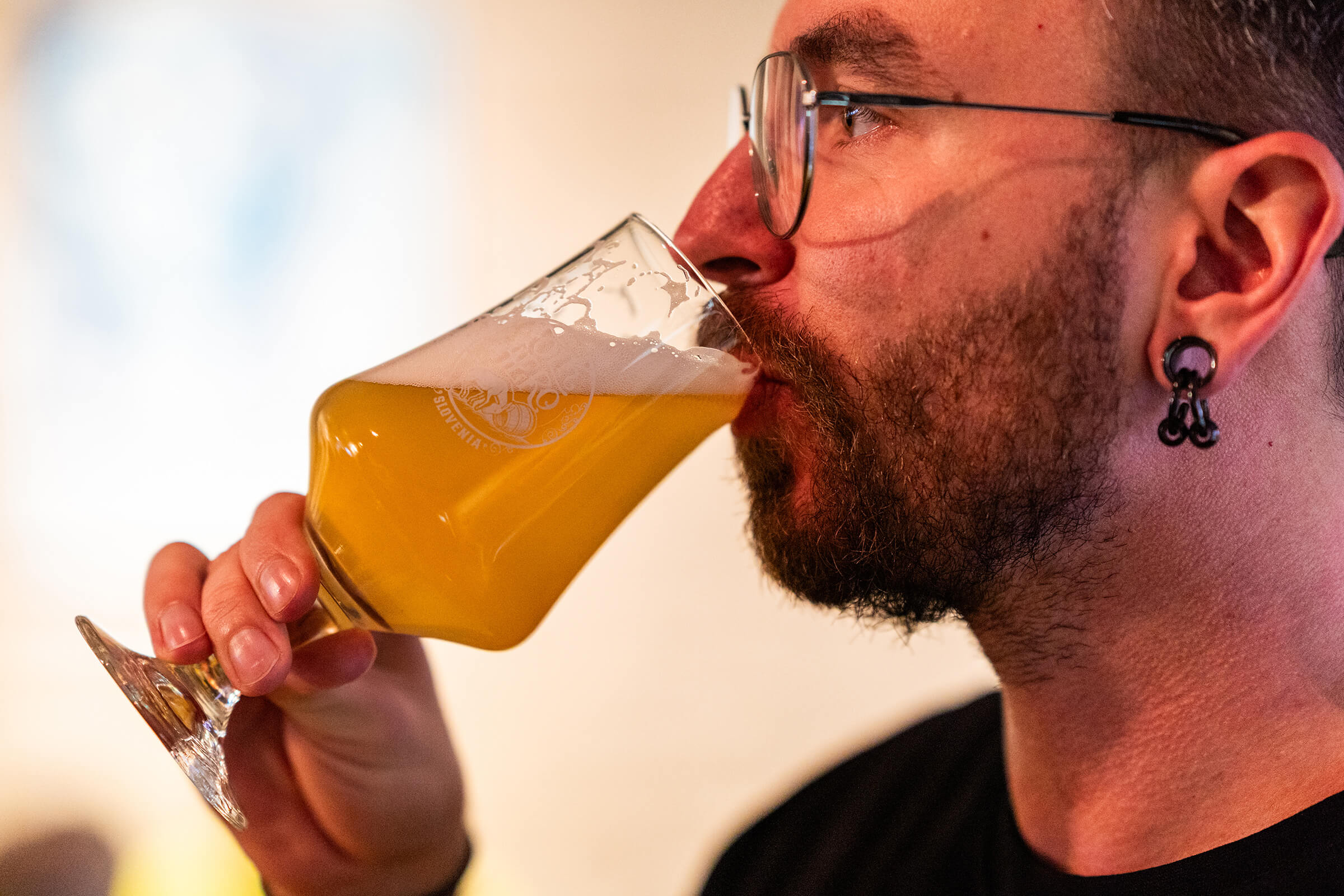 Guest drinking hazy beer from a Folk Hero glass