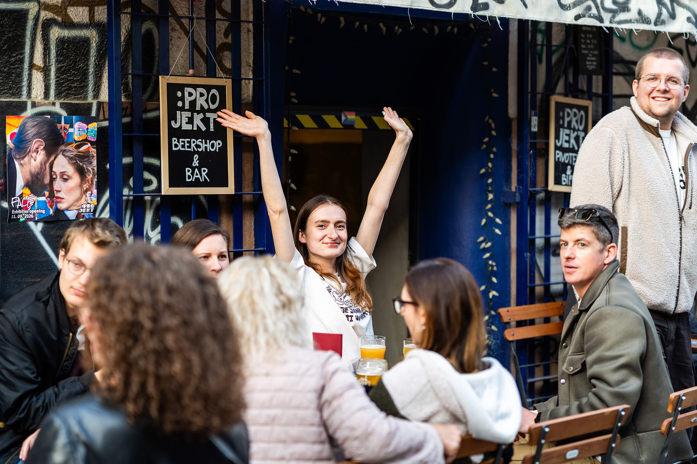 Guest raising her arms outside :Projekt Beershop & Bar at the Folk Hero grand opening