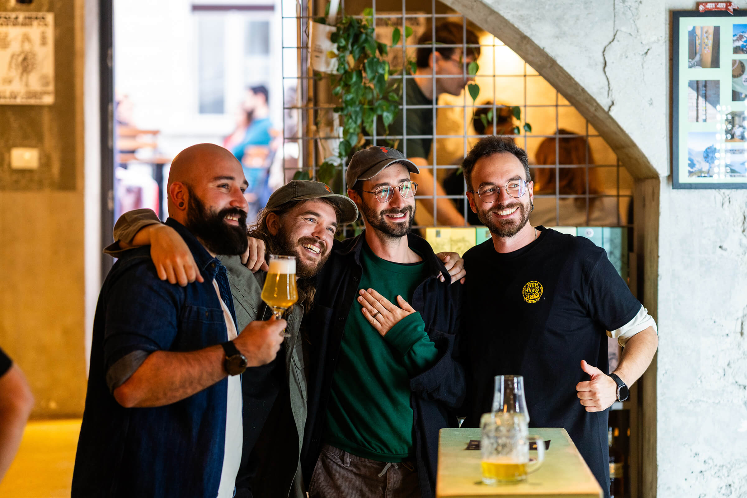 Four friends hugging at the :Projekt entrance during the Folk Hero grand opening