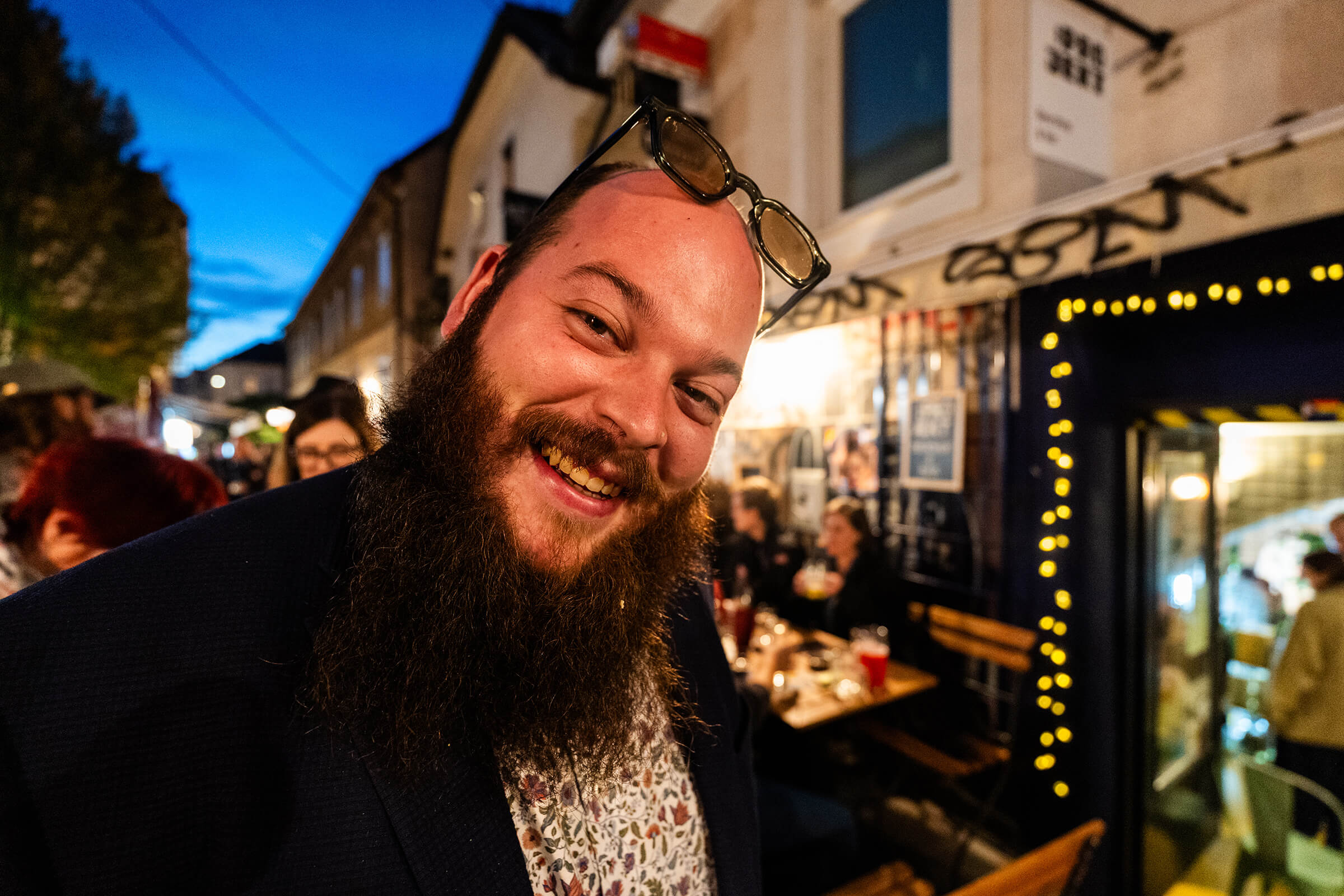 Laughing bearded guest outside :Projekt at dusk